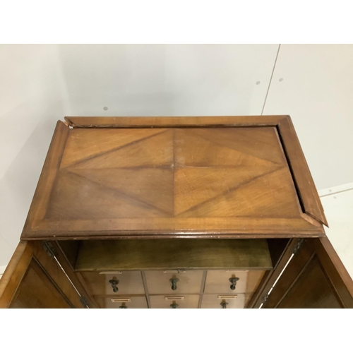 35 - An early 20th century walnut office cabinet fitted with nine deep drawers, width 61cm, height 106cm.... 