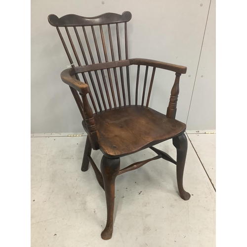 51 - An early 18th century ash and elm primitive Windsor elbow chair on cabriole front legs, width 52cm, ... 