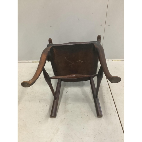 51 - An early 18th century ash and elm primitive Windsor elbow chair on cabriole front legs, width 52cm, ... 