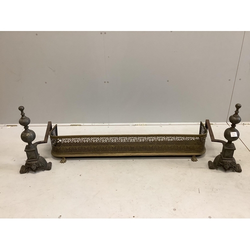 63 - A pair of cast bell metal and wrought iron andirons, height 53cm, and a brass fender. Condition - wo... 