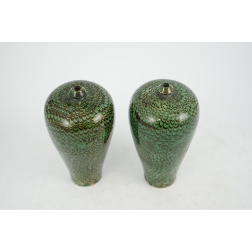 100 - A pair of Chinese Cizhou green glazed meiping, probably Ming dynasty, each covered in a combed dark ... 