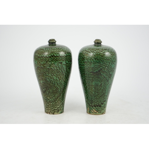 100 - A pair of Chinese Cizhou green glazed meiping, probably Ming dynasty, each covered in a combed dark ... 