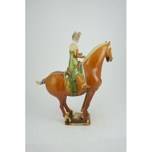 103 - A Chinese sancai glazed group of a horse and female rider, Tang or later, decorated in ochre green a... 