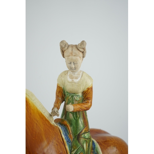 103 - A Chinese sancai glazed group of a horse and female rider, Tang or later, decorated in ochre green a... 