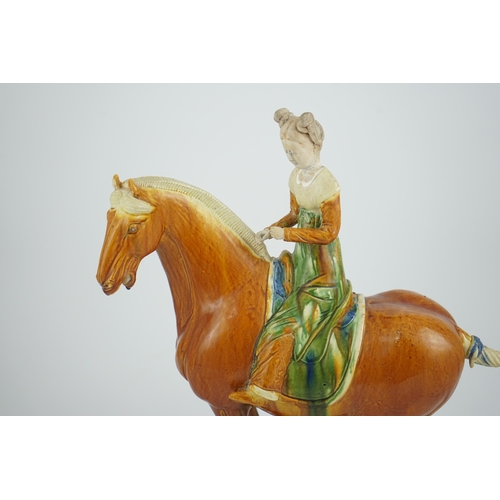 103 - A Chinese sancai glazed group of a horse and female rider, Tang or later, decorated in ochre green a... 