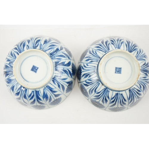 112 - A pair of Chinese blue and white Astor bowls, Kangxi period, each with a petal lobed rim the panel... 