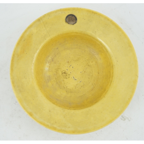 115 - A Chinese yellow glazed broad-rimmed bowl, Kangxi period (1662-1722), the broad rim above a deep cav... 