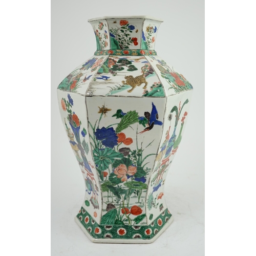 117 - A large Chinese famille verte hexagonal baluster vase, Kangxi period, the panelled body painted with... 