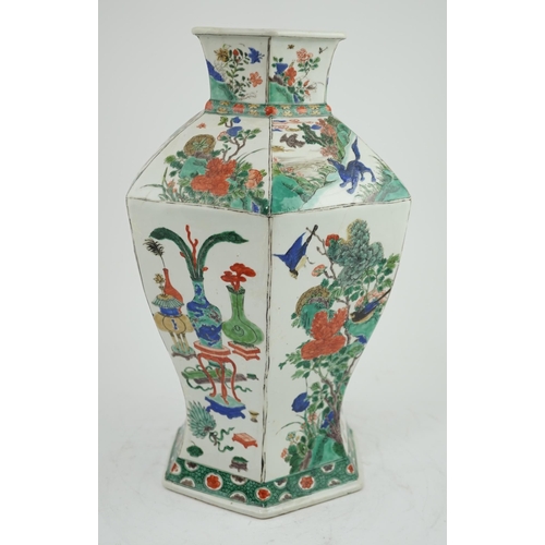 117 - A large Chinese famille verte hexagonal baluster vase, Kangxi period, the panelled body painted with... 