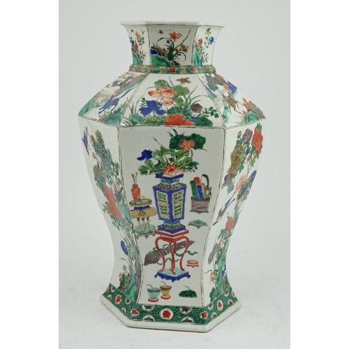 117 - A large Chinese famille verte hexagonal baluster vase, Kangxi period, the panelled body painted with... 