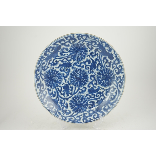 120 - A large Chinese blue and white lotus dish, Kangxi period, painted with five lotus flowers, scrolli... 