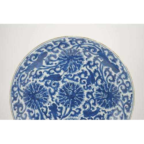 120 - A large Chinese blue and white lotus dish, Kangxi period, painted with five lotus flowers, scrolli... 