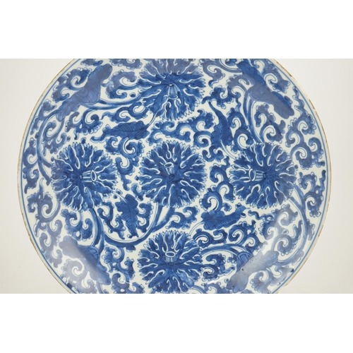 120 - A large Chinese blue and white lotus dish, Kangxi period, painted with five lotus flowers, scrolli... 