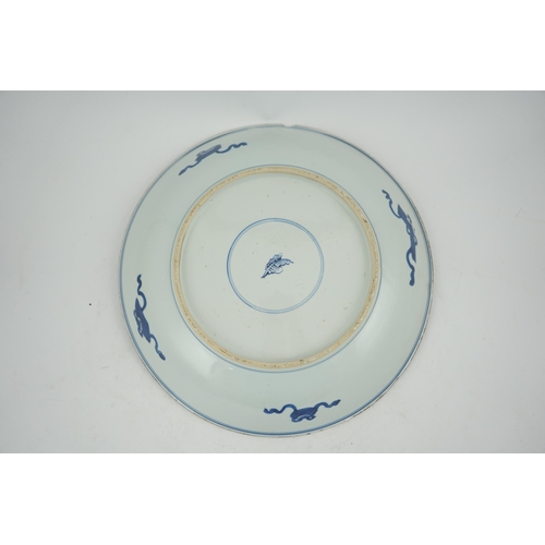 120 - A large Chinese blue and white lotus dish, Kangxi period, painted with five lotus flowers, scrolli... 