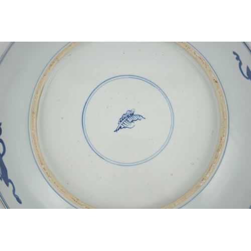 120 - A large Chinese blue and white lotus dish, Kangxi period, painted with five lotus flowers, scrolli... 