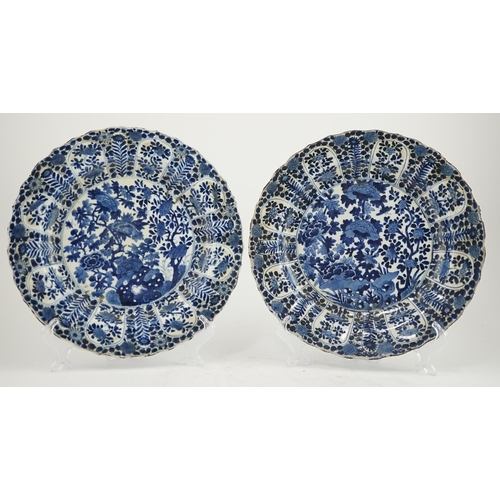 121 - A pair of Chinese blue and white chargers, Kangxi period (1662-1722), each painted to the centre wit... 