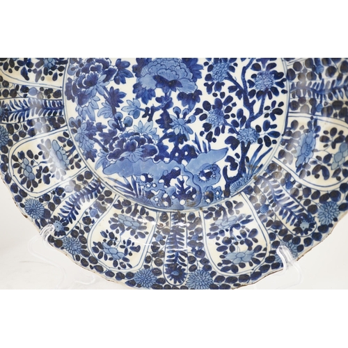 121 - A pair of Chinese blue and white chargers, Kangxi period (1662-1722), each painted to the centre wit... 