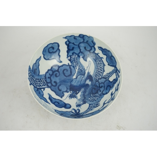 128 - A Chinese blue and white cloud and dragon bowl, Yongzheng mark and period (1723-35), painted to th... 