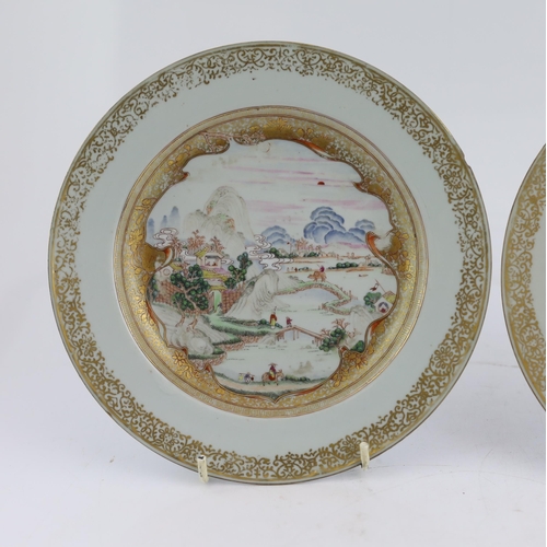 130 - A pair of Chinese famille rose landscape plates, Yongzheng-Qianlong period, each finely painted wi... 