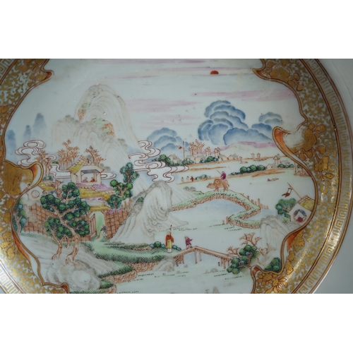 130 - A pair of Chinese famille rose landscape plates, Yongzheng-Qianlong period, each finely painted wi... 