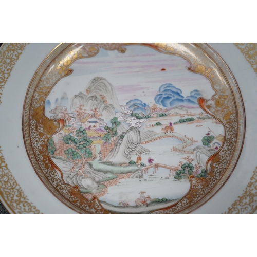 130 - A pair of Chinese famille rose landscape plates, Yongzheng-Qianlong period, each finely painted wi... 