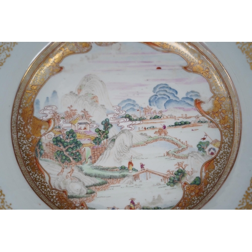 130 - A pair of Chinese famille rose landscape plates, Yongzheng-Qianlong period, each finely painted wi... 