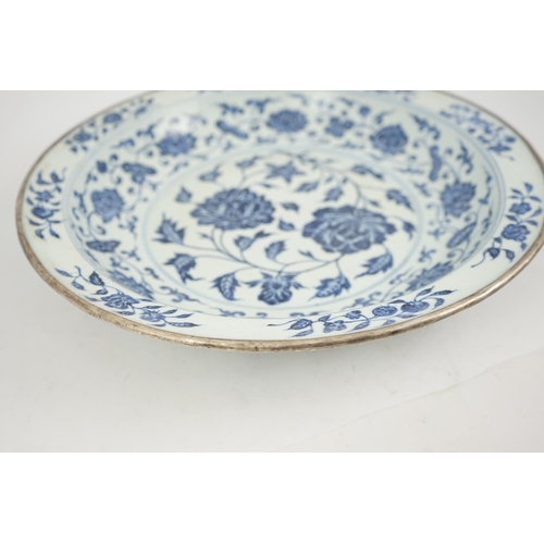 132 - A large Chinese Ming style blue and white dish, possibly 18th century, painted with peony sprays to ... 