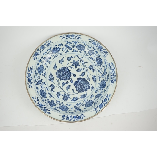 132 - A large Chinese Ming style blue and white dish, possibly 18th century, painted with peony sprays to ... 