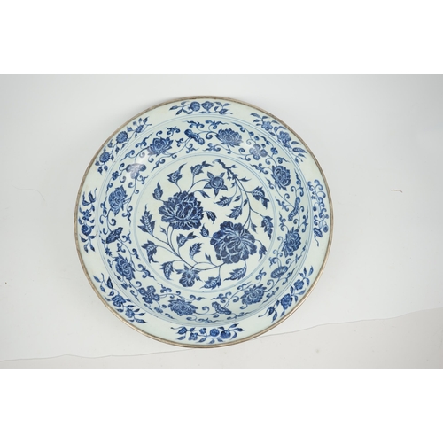 132 - A large Chinese Ming style blue and white dish, possibly 18th century, painted with peony sprays to ... 