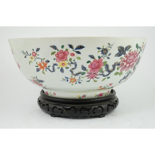 138 - A large Chinese famille rose punch bowl, Qianlong period, the exterior painted with flowers in a fen... 