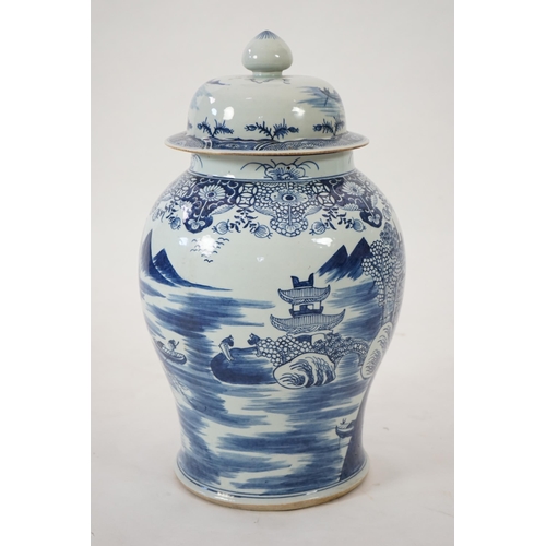 140 - A massive Chinese blue and white temple jar and cover, Qianlong period, painted with a temple pago... 