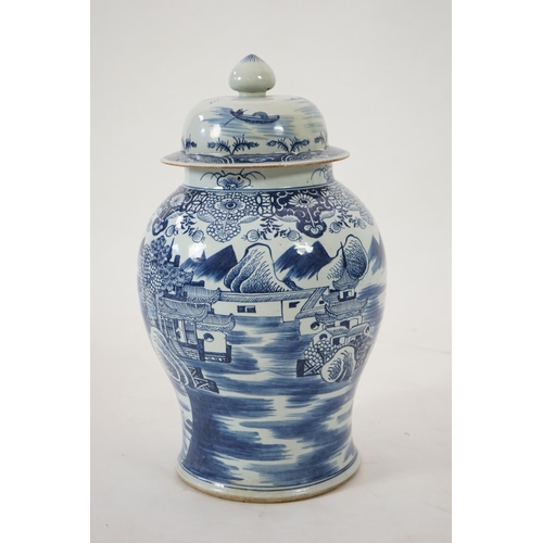 140 - A massive Chinese blue and white temple jar and cover, Qianlong period, painted with a temple pago... 