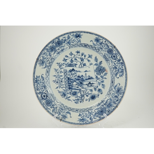 141 - A Chinese blue and white 'scroll and blossom' charger, Qianlong period, the centre painted with a la... 