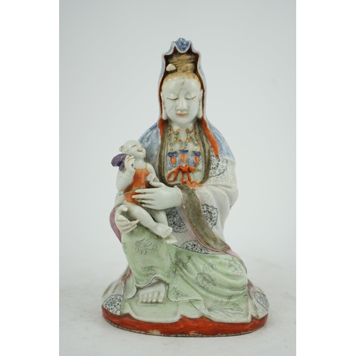 145 - A Chinese enamelled porcelain group of Guanyin holding a child, Qianlong period, seated in lalitasan... 