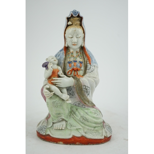 145 - A Chinese enamelled porcelain group of Guanyin holding a child, Qianlong period, seated in lalitasan... 