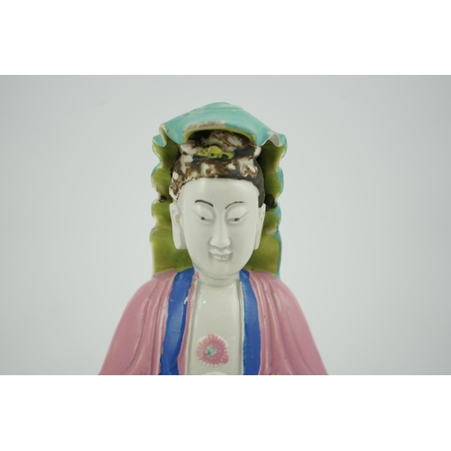 146 - A Chinese Dehua polychrome enamelled blanc de chine figure of Guanyin, late 18th century, seated on ... 