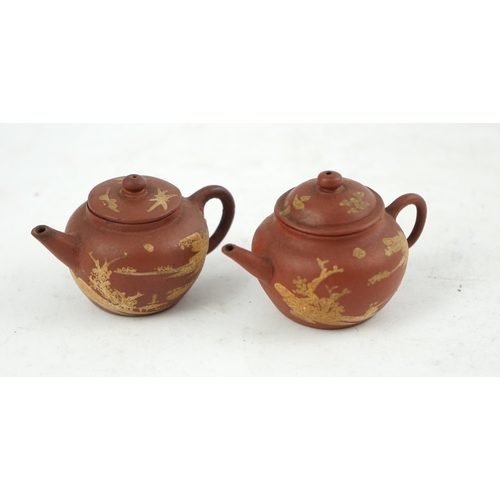 148 - Two Chinese Yixing slip-decorated miniature teapots and covers, 18th/19th century, each decorated in... 