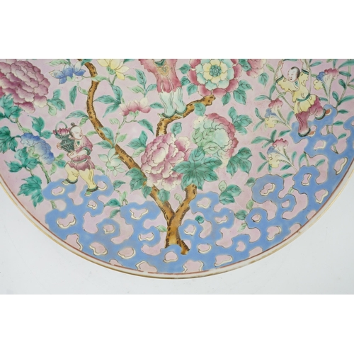 158 - A Chinese enamelled porcelain pink ground boys dish, mid 19th century, painted with five boys clam... 