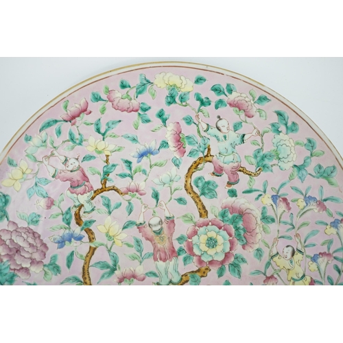 158 - A Chinese enamelled porcelain pink ground boys dish, mid 19th century, painted with five boys clam... 