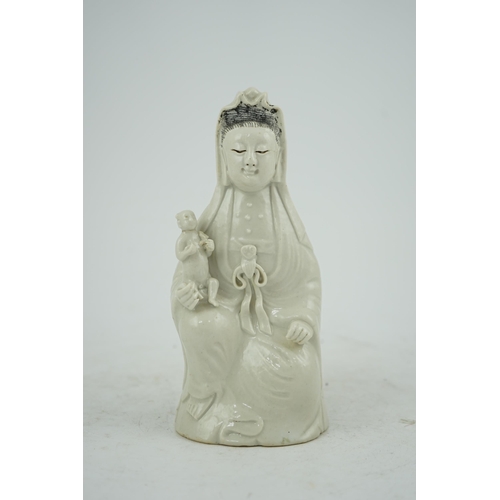 160 - A Chinese white glazed group of Guanyin and child, 18th/19th century, 20.5cm high