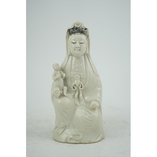 160 - A Chinese white glazed group of Guanyin and child, 18th/19th century, 20.5cm high