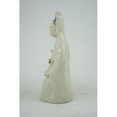 160 - A Chinese white glazed group of Guanyin and child, 18th/19th century, 20.5cm high