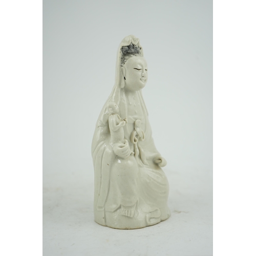 160 - A Chinese white glazed group of Guanyin and child, 18th/19th century, 20.5cm high