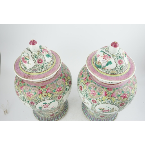 162 - A pair of large Chinese famille rose baluster jars and covers, Qianlong seal mark, but late 19th cen... 