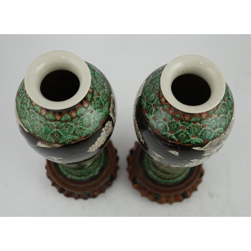 163 - A pair of Chinese black ground enamelled porcelain baluster vases, late 19th century, each painted i... 