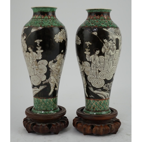 163 - A pair of Chinese black ground enamelled porcelain baluster vases, late 19th century, each painted i... 