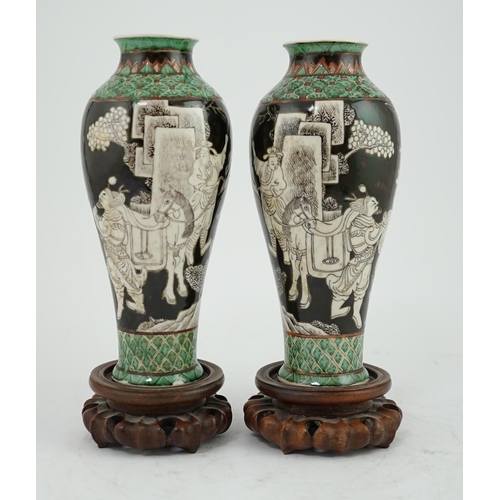 163 - A pair of Chinese black ground enamelled porcelain baluster vases, late 19th century, each painted i... 