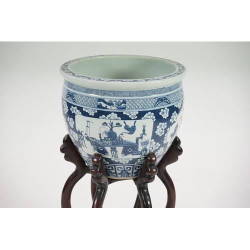 165 - A large Chinese blue and white Hundred Antiques jardinere and hongmu stand, late 19th/early 20th c... 