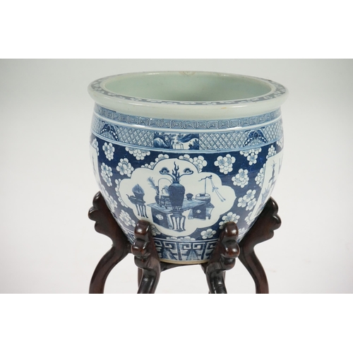 165 - A large Chinese blue and white Hundred Antiques jardinere and hongmu stand, late 19th/early 20th c... 