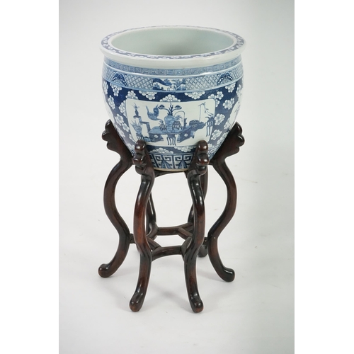 165 - A large Chinese blue and white Hundred Antiques jardinere and hongmu stand, late 19th/early 20th c... 